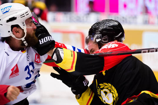 Thomas Larkin of Adler Mannheim fights Lukas Kilström of