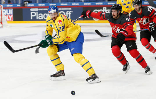 Dick Axelsson #28, Sweden and	Charles Genoway #4, Canada