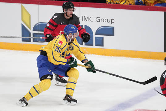 Dick Axelsson #28, Sweden and	Charles Genoway #4, Canada