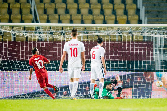 Goran Pandev of Macedonia scores 1-0 behind goalkeeper Sten