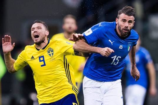 Sveriges Marcus Berg i en närkamp med Italiens Andrea