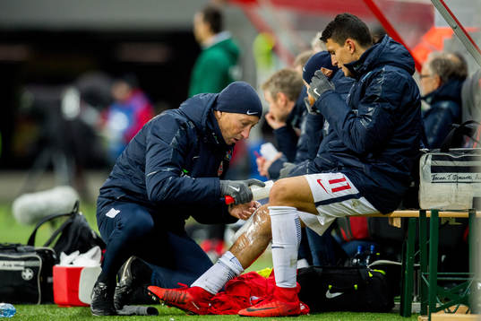 Mohamed Elyounoussi of Norway gets treatment from physical