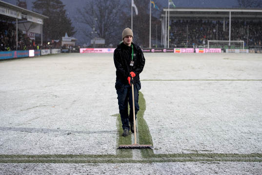 En funktionär rensar linjerna från snö