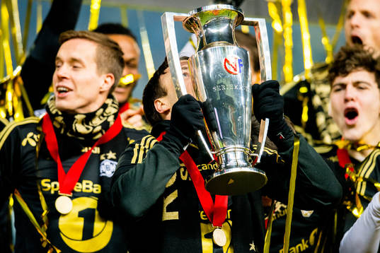Mike Jensen of Rosenborg kisses the league trophy