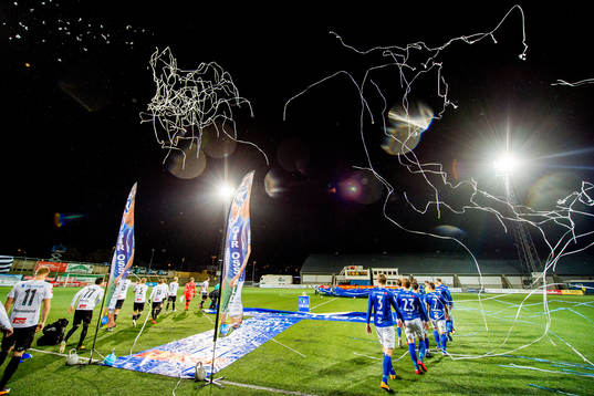 The teams enter the pitch
