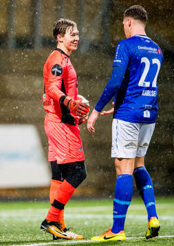 Goalkeeper Mathias Dyngeland of Sogndal talks to Michael