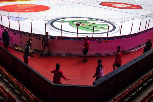 Players of Ocelari Trinec plays football by the rink prior