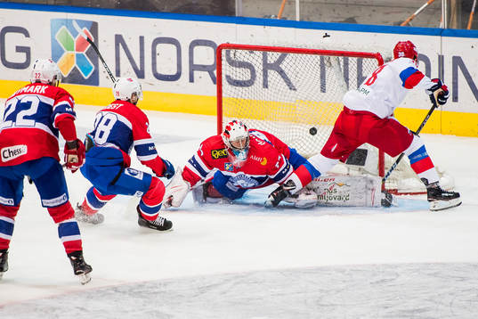 Mikhail Naumenkov of Russia scores 1-1 behind goaltender