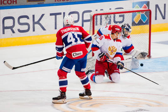 Patrick Thoresen of Norway scores 1-0 behind goaltender