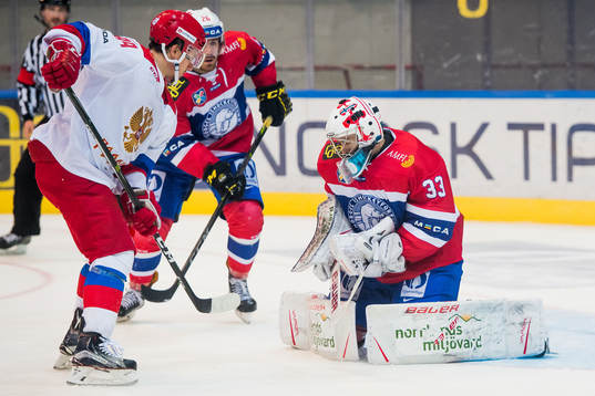 Alexander Khokhlachyov of Russia and goaltender Henrik