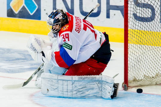 The puck gets past goaltender Aleksandr Sharychenkov of
