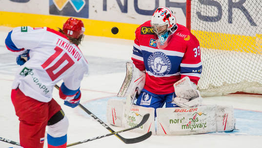 Viktor Tikhonov of Russia and Goaltender Henrik Haukeland