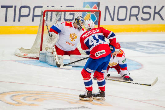 Patrick Thoresen of Norway scores 1-0 behind goaltender
