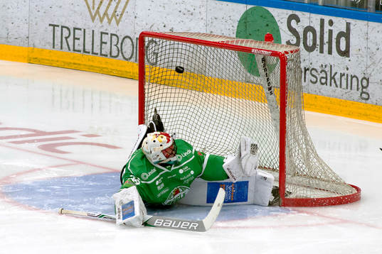 Rögles målvakt Justin Pogge följer pucken in i mål