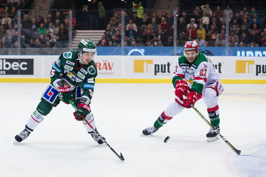 Frölundas Adam Almqvist före Moras Matt Bailey på pucken
