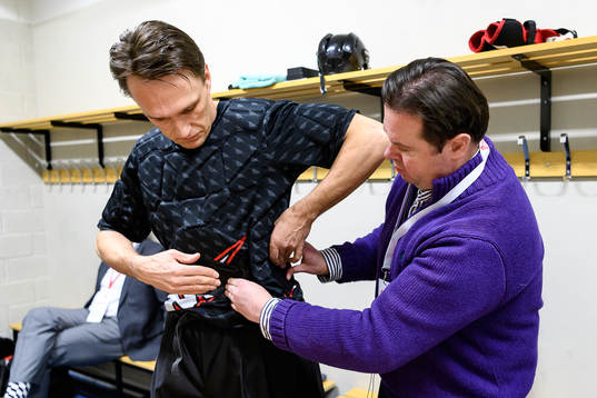 The referee team gets mics prior to the CHL final game