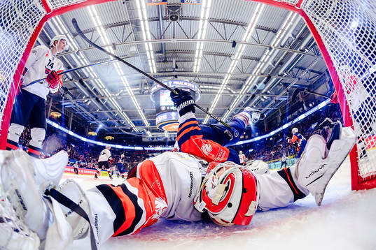 Martin Lundberg of Växjö falls into goals Juho Olkinuora