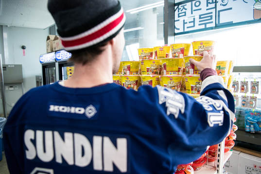 A supporter in a small Korean shop prior the Men's Ice