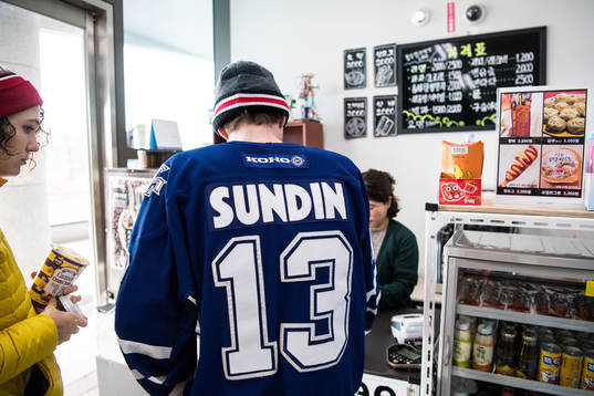 A supporter in a small Korean shop prior the Men's Ice
