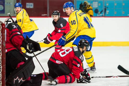 Joakim Lindström of Sweden and Goaltender Ben Scrivens of