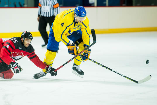 Maxim Lapierre of Canada and Staffan Kronwall of Sweden