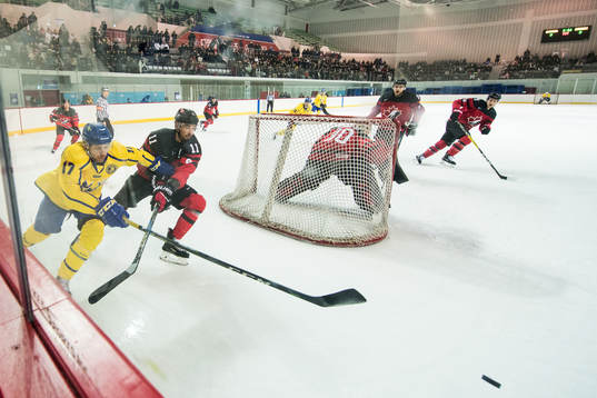 Pär Lindholm of Sweden in action with Chris Kelly of Canada