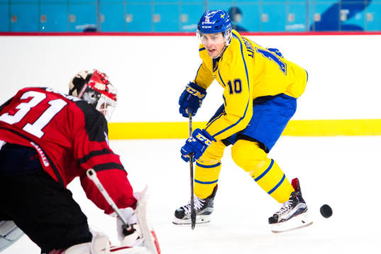 Joakim Lindström of Sweden against Goaltender Kevin Poulin