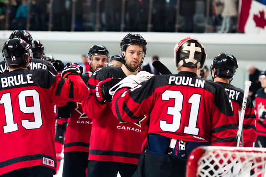 Goaltender Kevin Poulin of Canada celebrates the win with