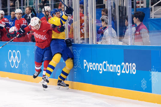 Mathias Trettenes of Norway tackles Alexander Bergström of