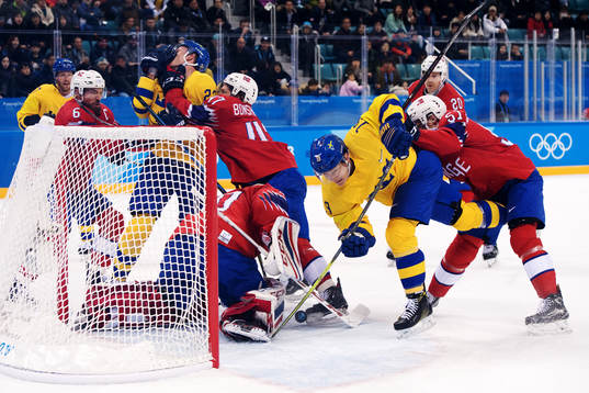Patrik Zackrisson of Sweden in a duel with Goaltender Lars