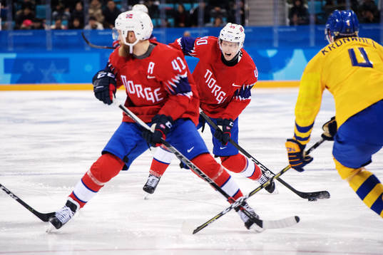 Ken André Olimb of Norway shoots in the Men's Ice Hockey
