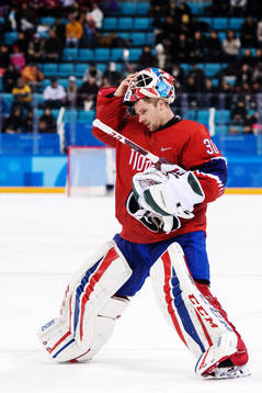 Goaltender Lars Haugen of Norway looks dejected in the