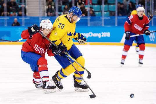 Aleksander Bonsaksen of Norway  in a fight for the puck