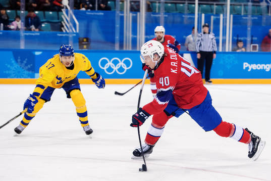 Ken André Olimb of Norway shoots in the Men's Ice Hockey