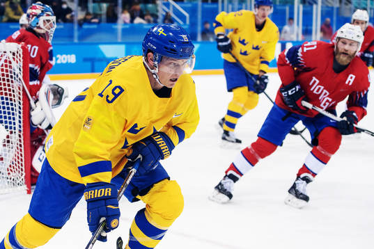 Patrik Zackrisson of Sweden compete for the puck in the