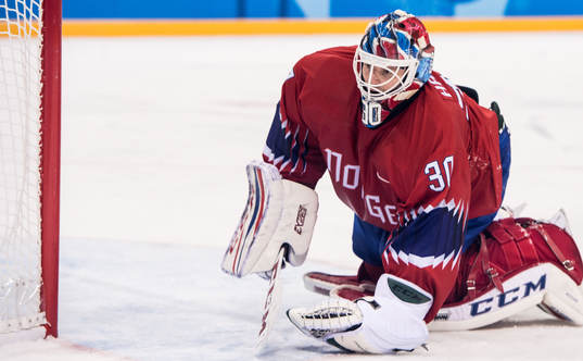 Goaltender Lars Haugen of Norway looks dejected in the