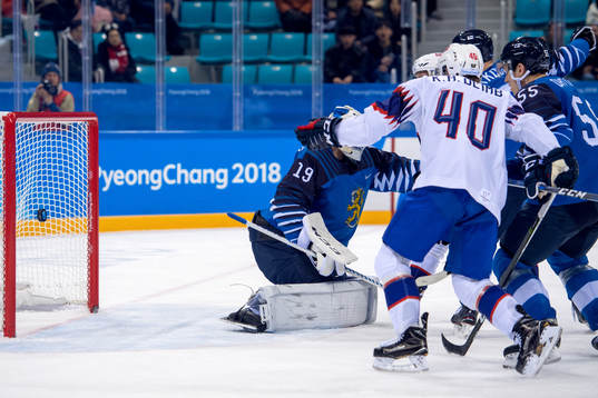 The puck hits the bar behind Goaltender Mikko Koskinen of