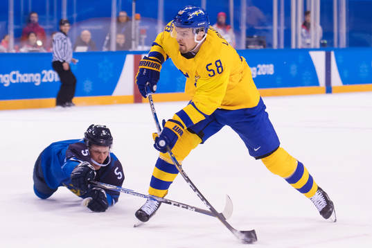 Lasse Kukkonen of Finland fails to stop Anton Lander of