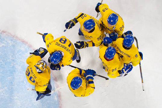 The players of Sweden gather around goaltender Viktor Fasth