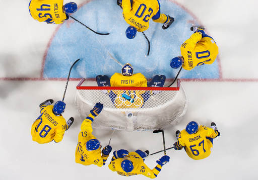 Sweden's players gather around goaltender Viktor Fasth