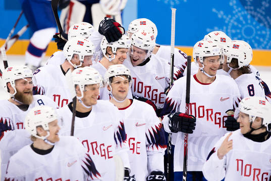 Team Norway celebrates with the game winning goal scorer