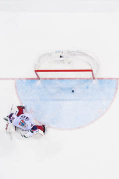 Goaltender Lars Haugen of Norway lets in a goal in the