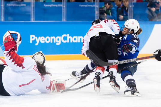 Marie-Philip Poulin of Canada against Brianna Decker of USA