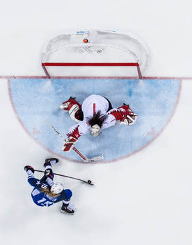 Gigi Marvin of USA against Goaltender Shannon Szabados of