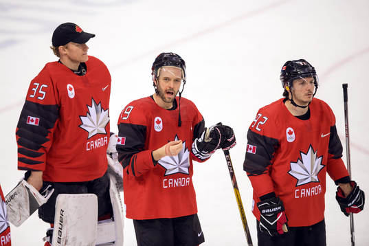 Goaltender Justin Peters, Andrew Ebbett and Christian