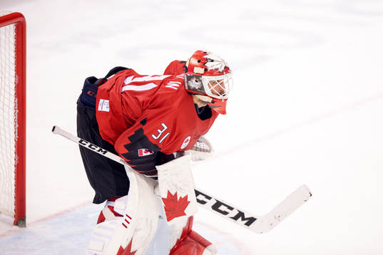 Goaltender Kevin Poulin of Canada looks dejected in the