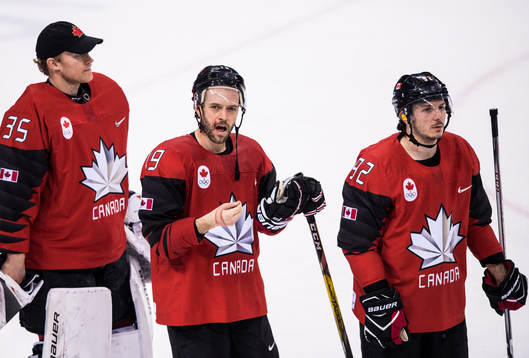 Goaltender Justin Peters, Andrew Ebbett and Christian