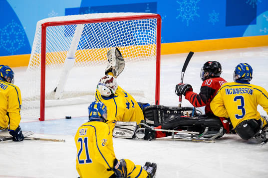 Ben Delaney of Canada scores a goal behind goaltender Ulf