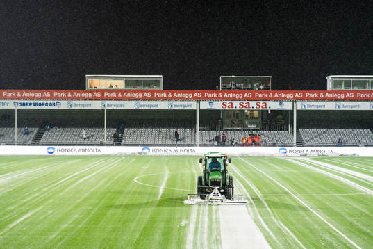 A tractor clean the field for snow