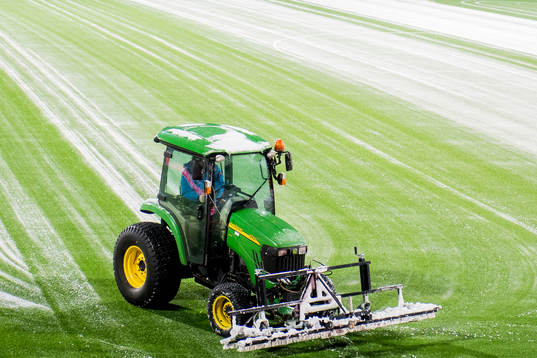 A tractor clean the field for snow